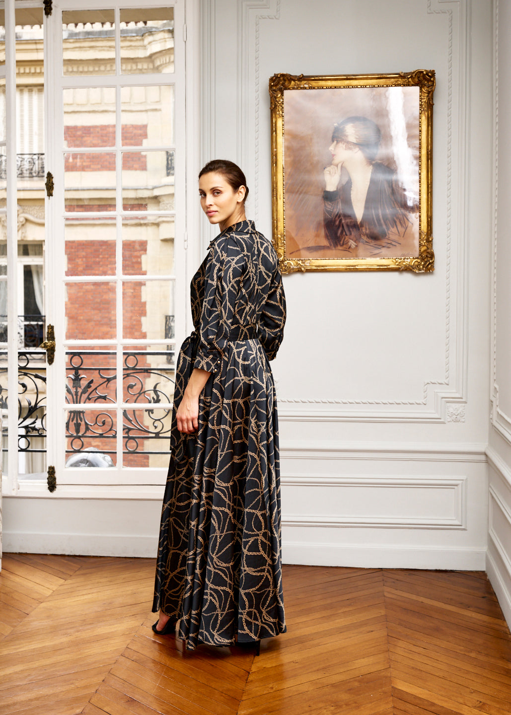 Woman models black and gold maxi dress