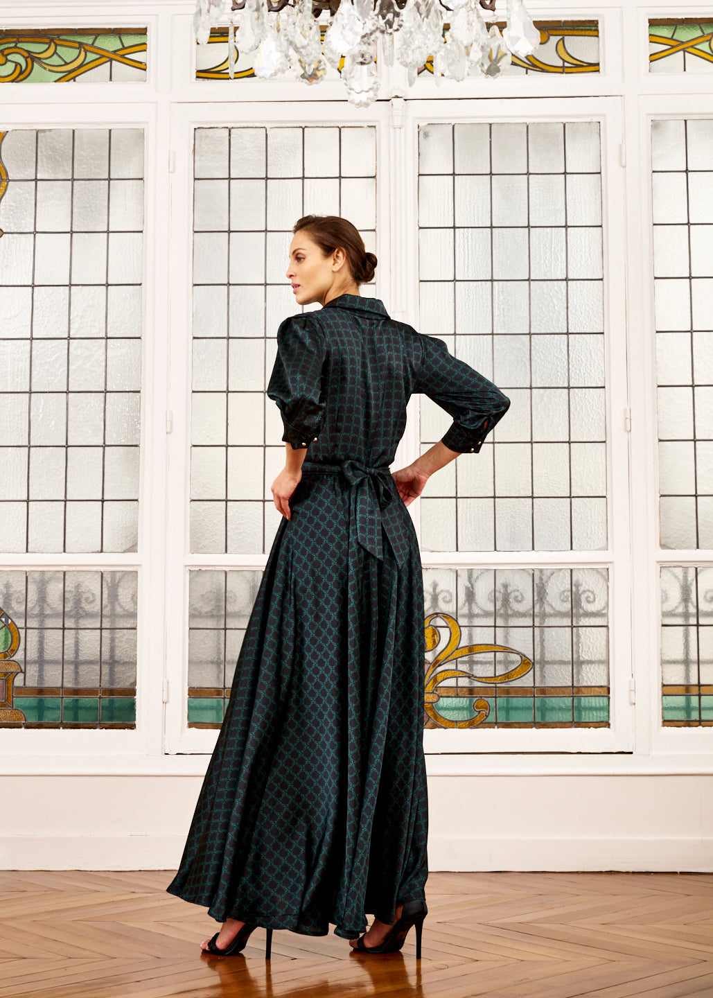 Woman models Elegance Miss emerald green and black dress