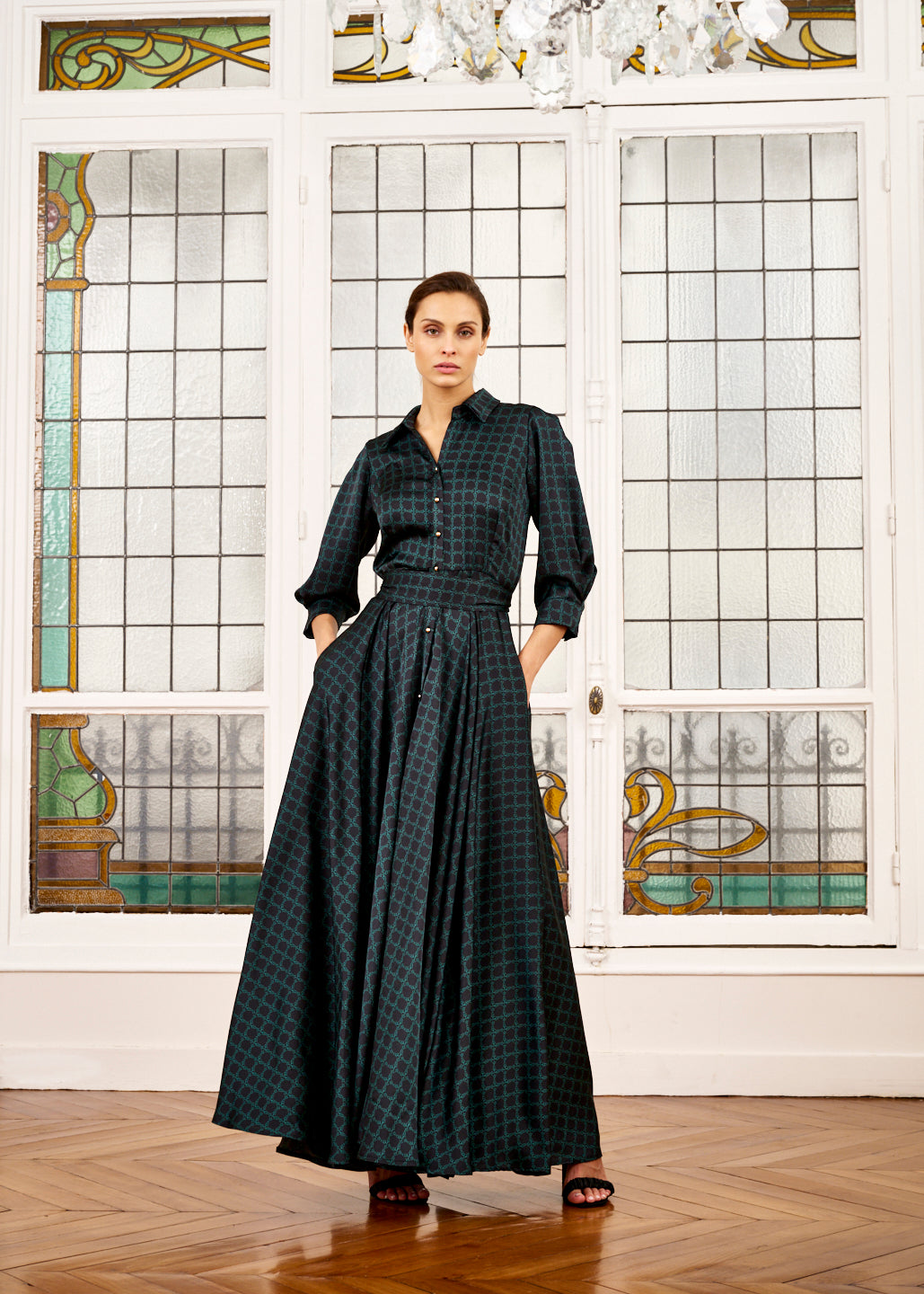 Woman models emerald green and black dress