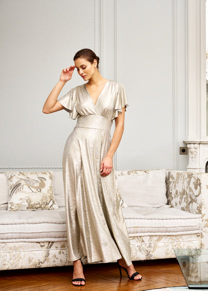 Woman models formal gold maxi dress