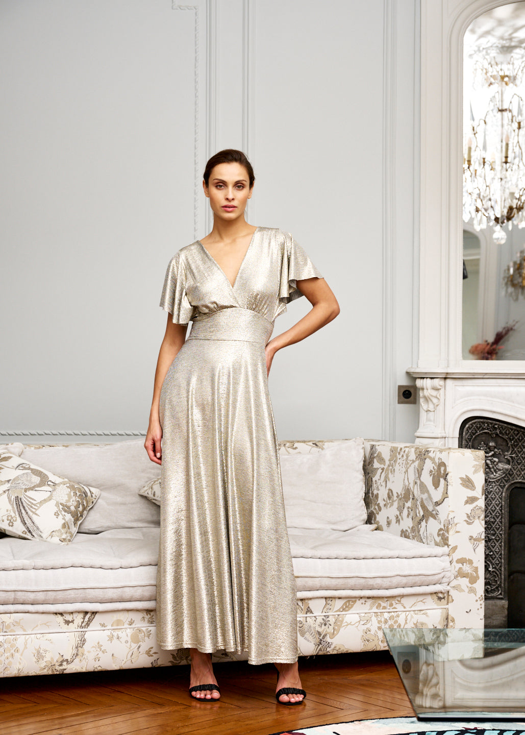 Woman models long, gold formal dress